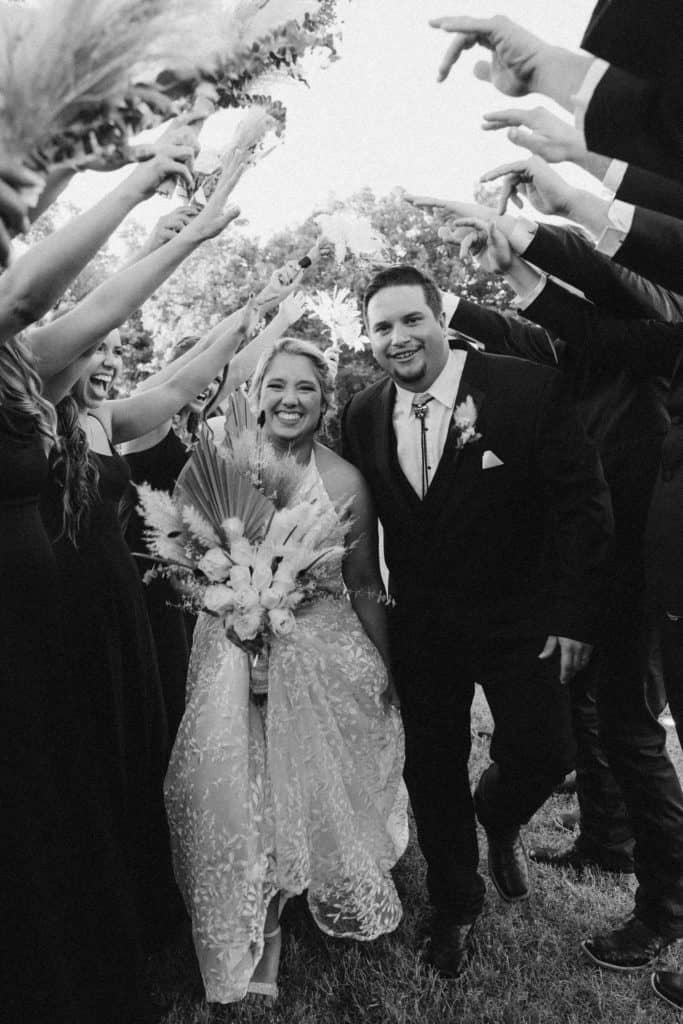 black and white photo of the bride and groom with their wedding party
